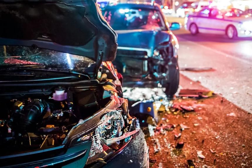 multi-vehicle car accident on a city street at night.